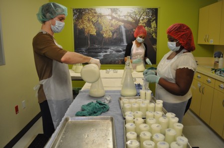 three 3 people processing milk at mother's milk bank